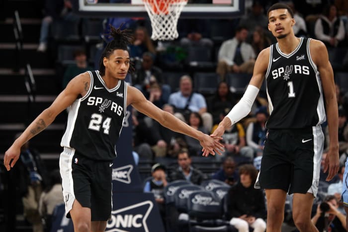 Jan 2, 2024; Memphis, Tennessee, USA; San Antonio Spurs guard Devin Vassell (24) reacts with center Victor Wembanyama (1) during the second half against the Memphis Grizzlies at FedEx Forum.